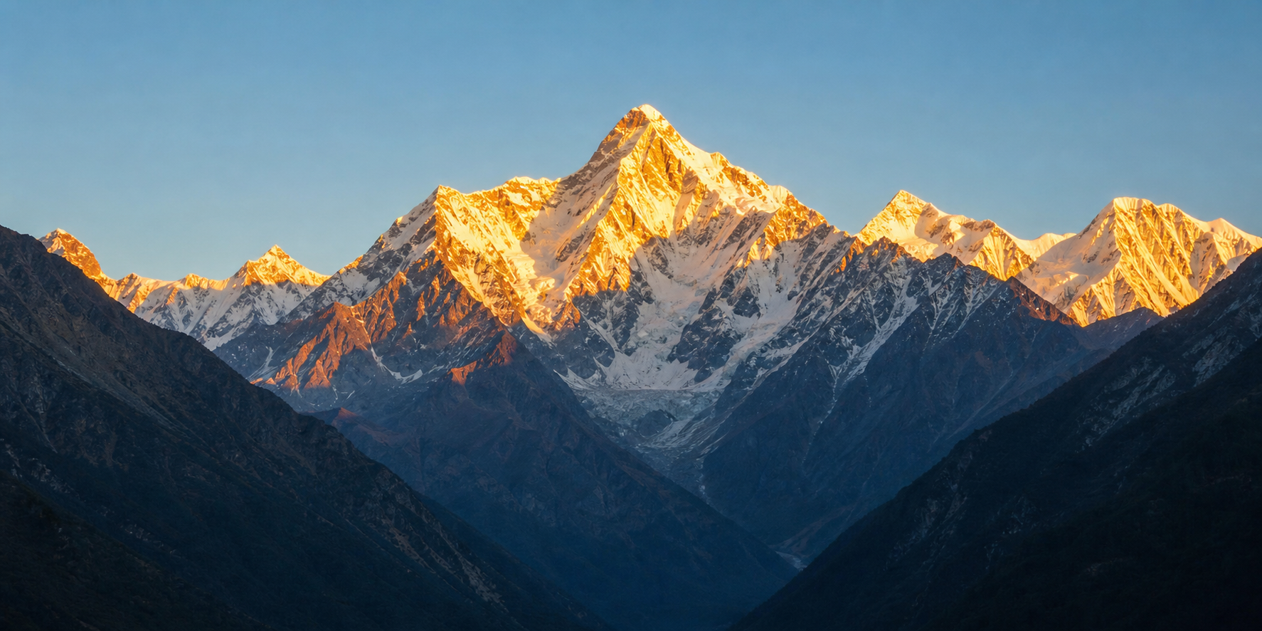 Golden sunrise over snowy Himalayan peaks